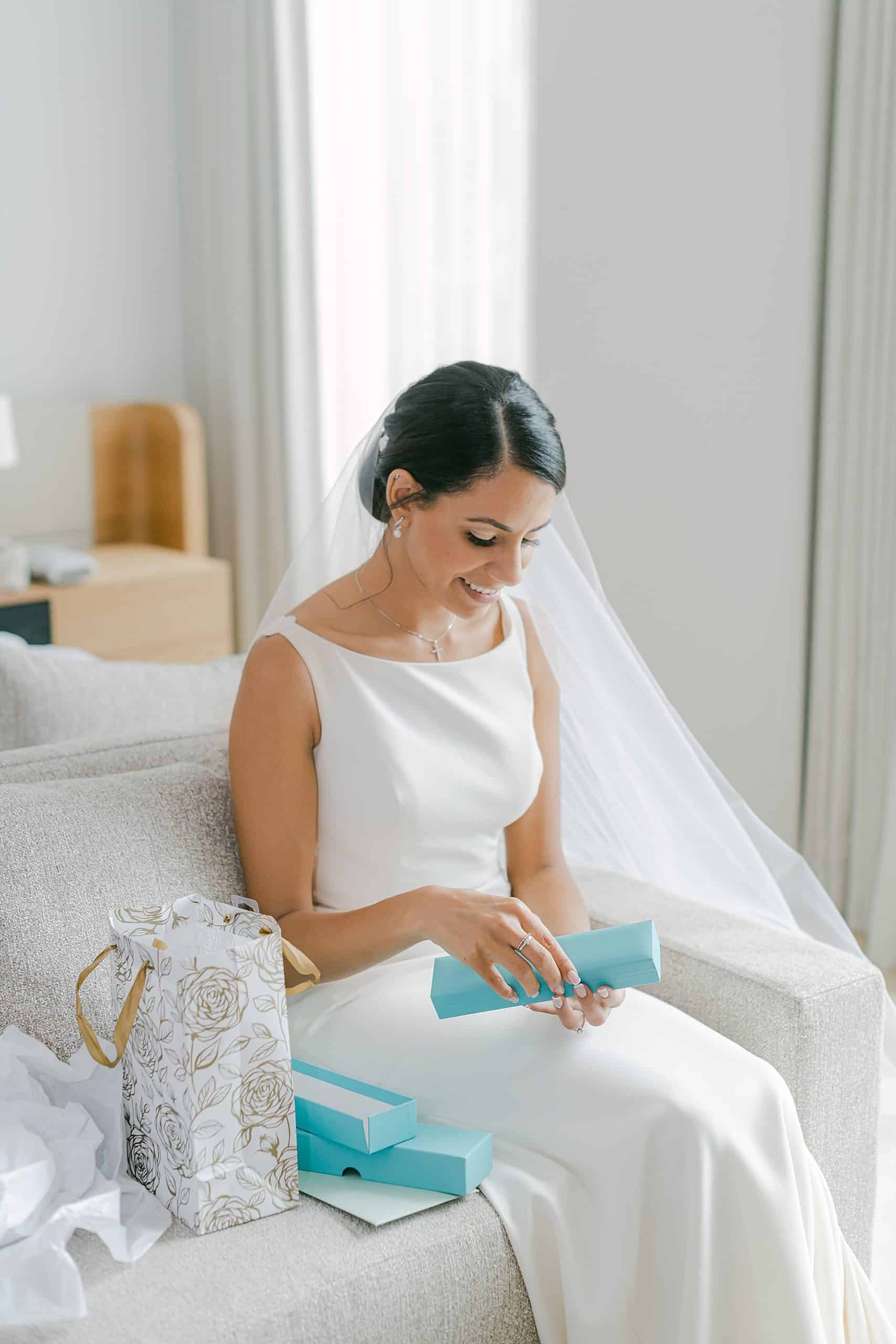 Burlington bride getting ready in her studio suite at the Pearle Hotel & Spa opening Tiffany & Co gift