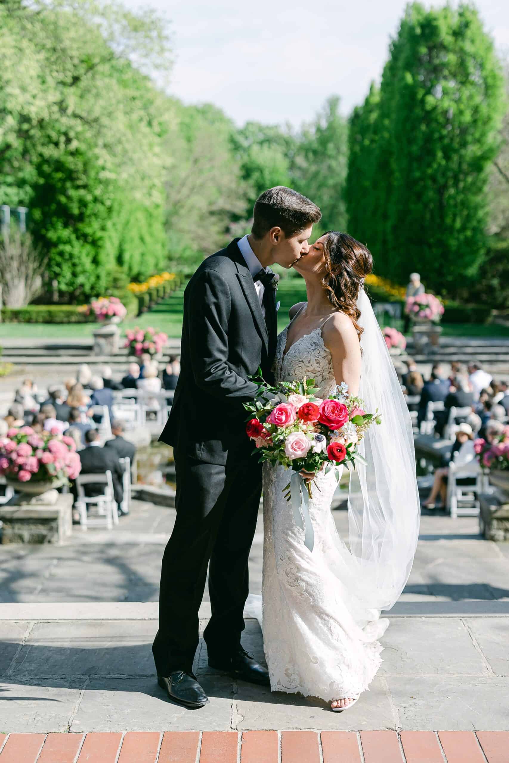 couple kiss during outdoor ceremony at graydon hall