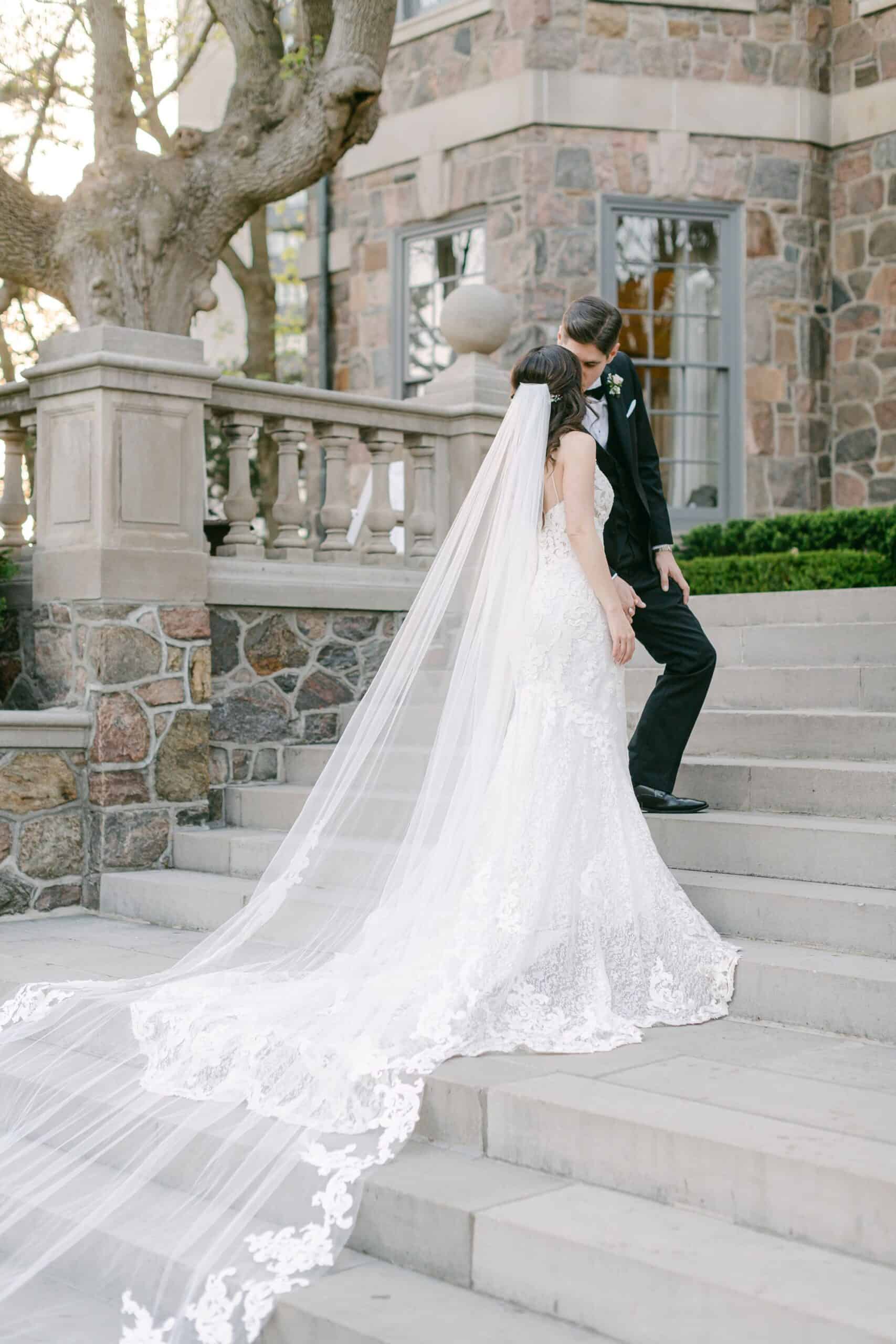 maggie sottero wedding dress with catedral veil on steps of graydon hall manor